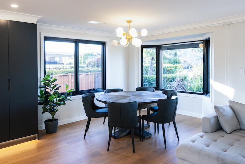 Experience modern elegance with this stunning dining room renovation by Dura Group, a leading Sydney-based construction company. Specializing in home upgrades across the Sutherland Shire, Bayside, and Inner West, Dura Group brings 27 years of expertise to every project. This beautifully designed space features sleek black furniture, a chic chandelier, and ample natural light, creating a welcoming environment for dining and socializing. At Dura Group, we prioritize time efficiency, budget-conscious planning, and open communication, ensuring your renovation is seamless and stress-free. Trust, transparency, and tailored building solutions are at the core of what we do, delivering high-quality results without compromise. Whether you're looking to update your dining area or transform your entire home, our team of experts guides you through every step, turning your vision into reality. Discover the difference with Dura Group and elevate your living space today. Contact us now to start your renovation journey with a company that puts homeowner satisfaction first.