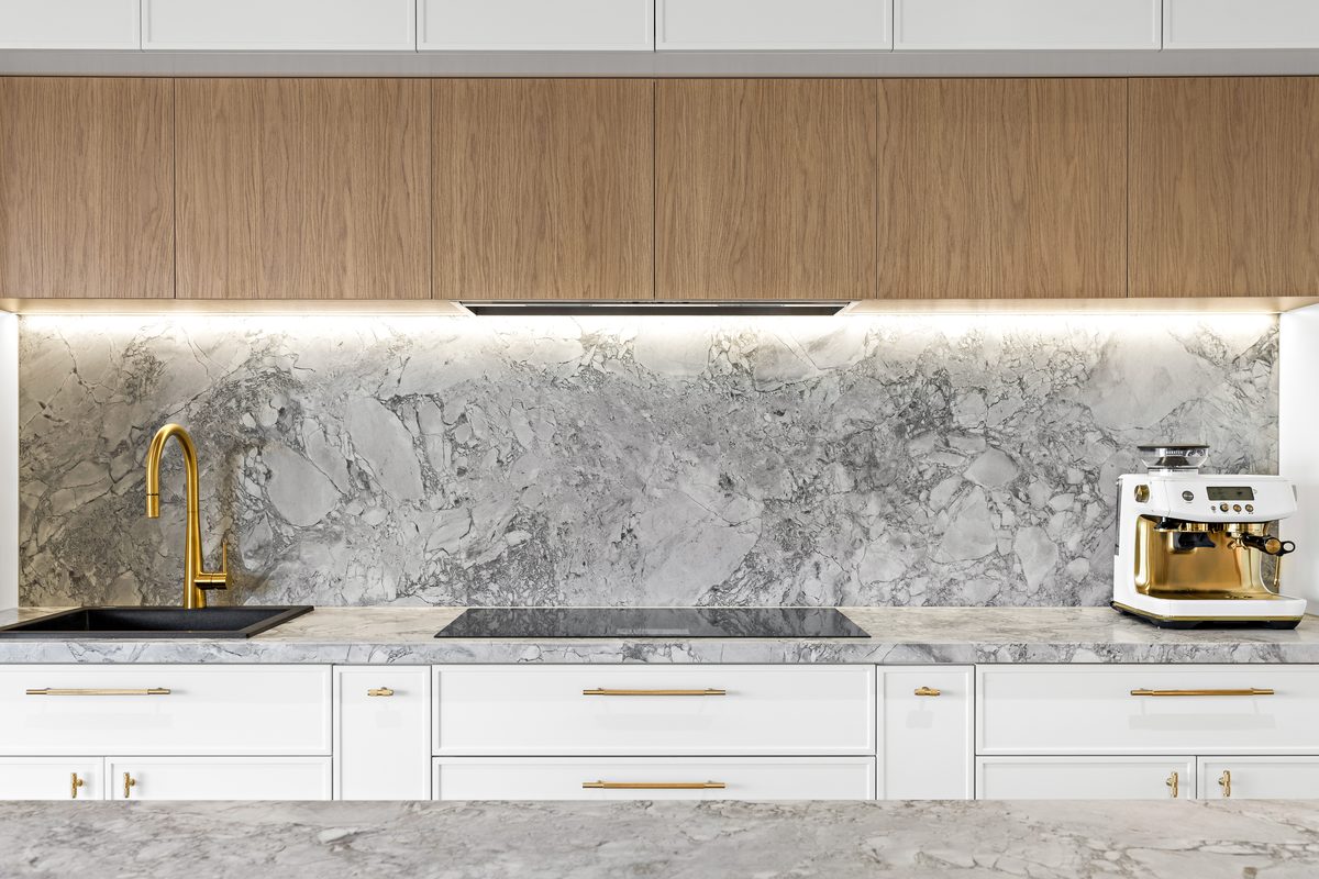 Kitchen renovation with feature stone splashback and timber over