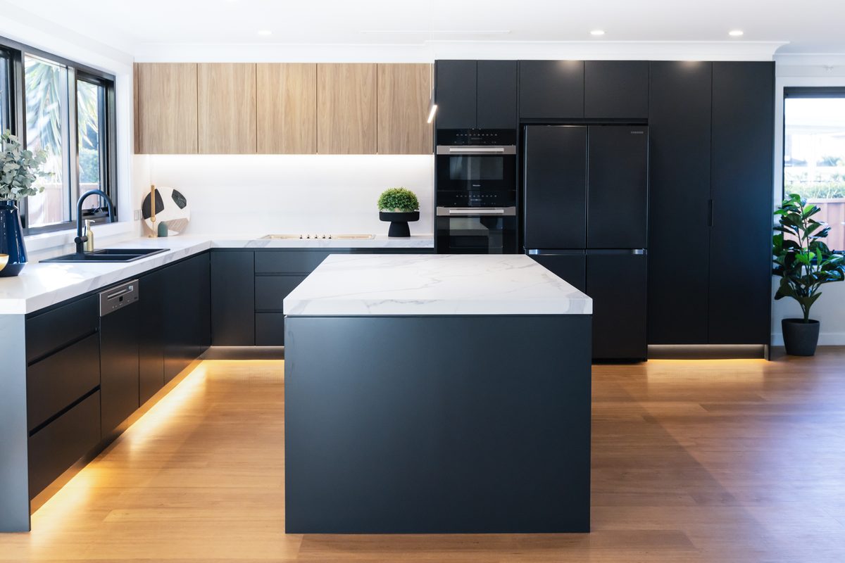 Kitchen renovation with navy cabinetry and marble island